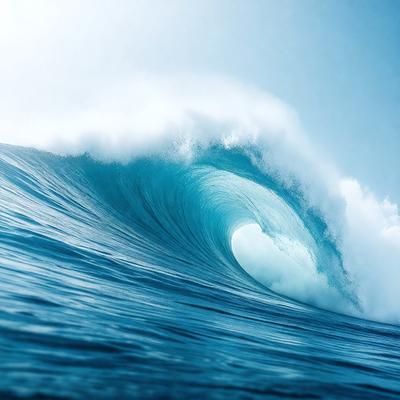 The primary subject of the image is a large wave in the ocean. The wave is crashing down, creating a powerful and dynamic scene. The setting is the ocean, with the wave being the main focus of the image. The visual style is a photo, capturing the natural beauty of the ocean and the force of the wave. The colors and mood of the image are predominantly blue, with the wave and the ocean creating a sense of depth and tranquility.
